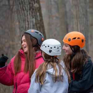 teens in helmets waiting for the zipline