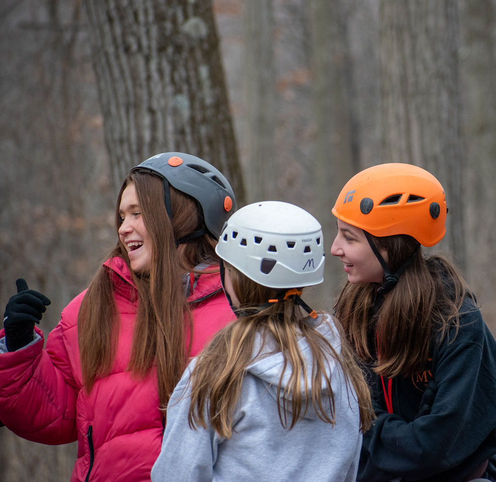 teens in helmets waiting for the zipline